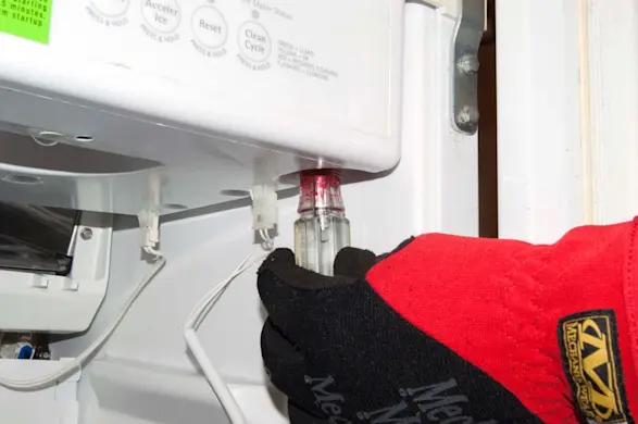 PHOTO: Remove the screw from the control board housing.
