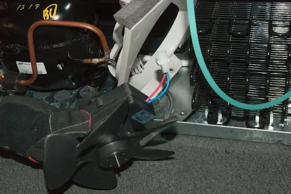 PHOTO: Remove the condenser fan from the bracket.