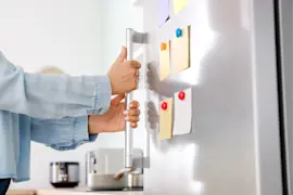 How to reset the door alarm on a GE refrigerator