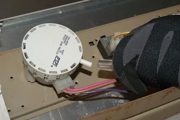 PHOTO: Connect the air hose to the new water level pressure switch.
