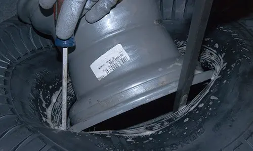 PHOTO: Pry the new tire onto the rim.