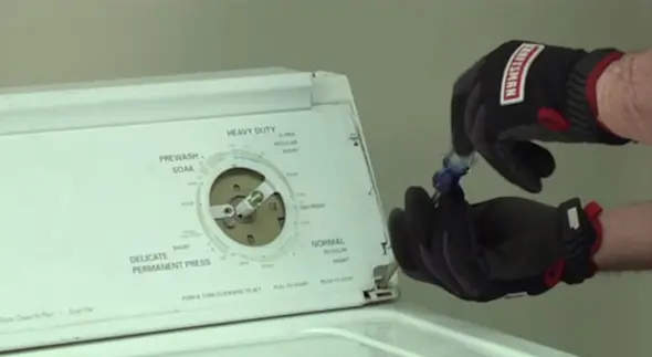 PHOTO: Reinstall the control console mounting screws.