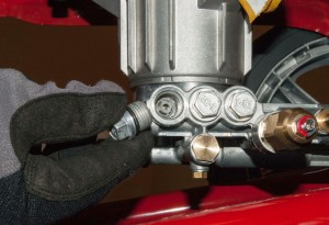 PHOTO: Remove the manifold check valve caps.