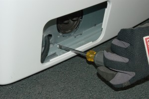 PHOTO: Reinstall the screw at the base of the washer in the pump housing opening.