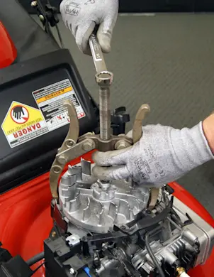 PHOTO: Position the 2-jaw puller on the flywheel.
