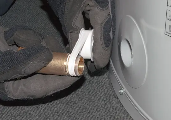 PHOTO: Apply thread sealing tape to the drain valve.