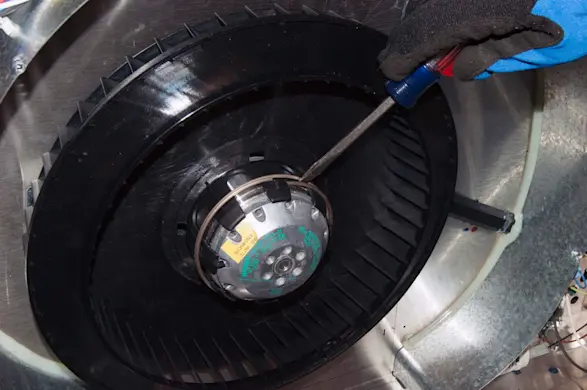 PHOTO: Pry off the blade spring clamp.
