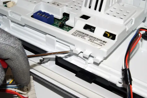 PHOTO: Release the control board locking tabs.