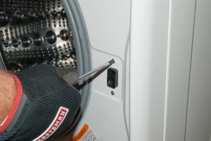 PHOTO: Remove the mounting screws from the front of the door lock.