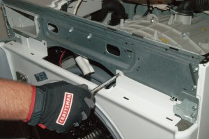 PHOTO: Reinstall the mounting screws in the top of the front panel.