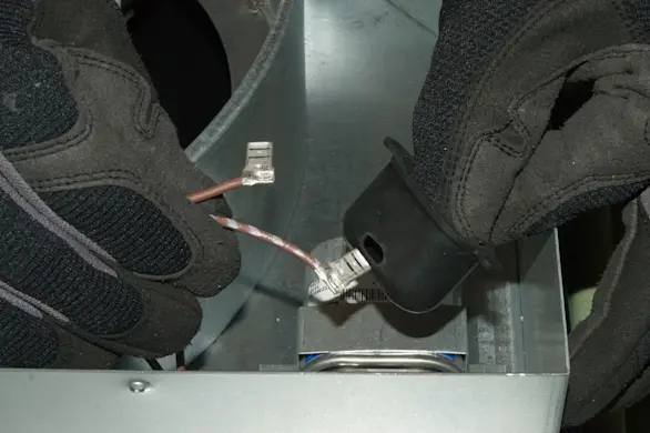 PHOTO: Feed the motor capcitor wires through the rubber boot.