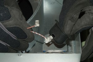 PHOTO: Feed the motor capcitor wires through the rubber boot.