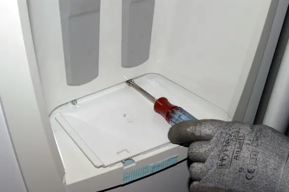 PHOTO: Remove the dispenser housing base screws.