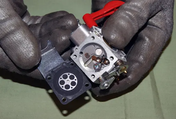 PHOTO: Remove the carburetor bottom cover.