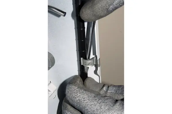 PHOTO: Release the wire harness from the clips on the side of the top panel.