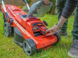Image of battery-operated lawn mower as an introduction image for article on whether you should buy a cordless lawn mower.