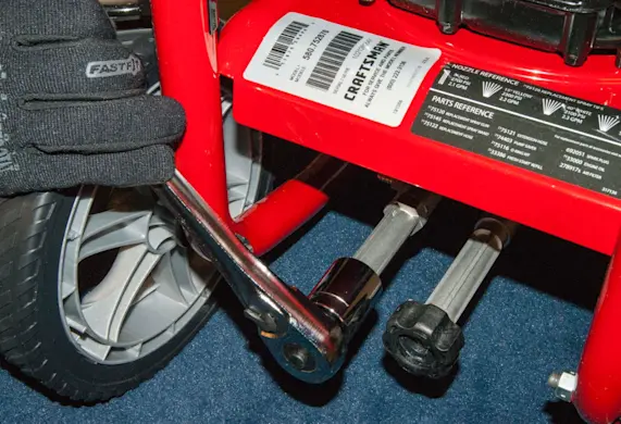PHOTO: Remove the high-pressure outlet fitting.