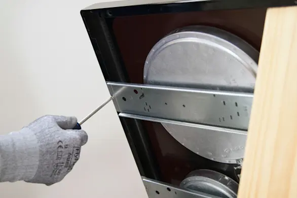 PHOTO: Remove the front bracket screws.