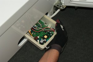 PHOTO: Connect the wires and push the control board into the cabinet.