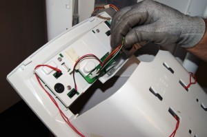 PHOTO: Turn the dispenser housing around to access the wiring connections.