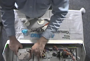 Introduction image for replacing the washer timer and other control components on an Amana Searcy top-load washing machine.