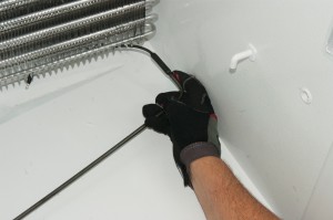 PHOTO: Push the new defrost heater into place.