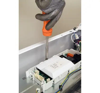 PHOTO: Remove the control board mounting screw.
