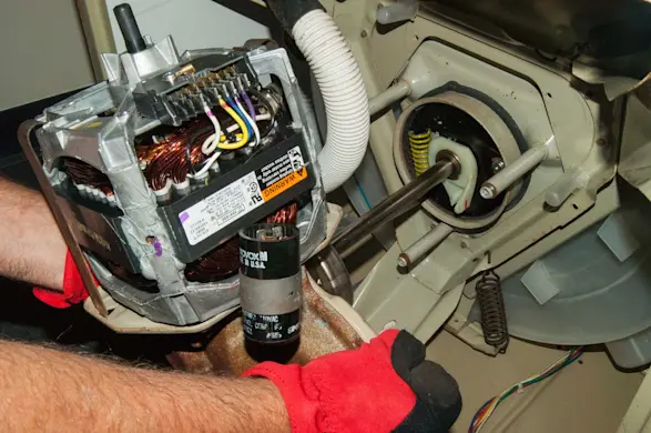 PHOTO: Pull the transmission and drive motor out of the washer.