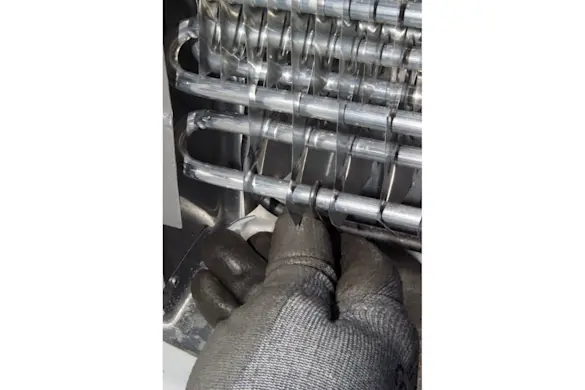 PHOTO: Unhook the defrost heater hangers.