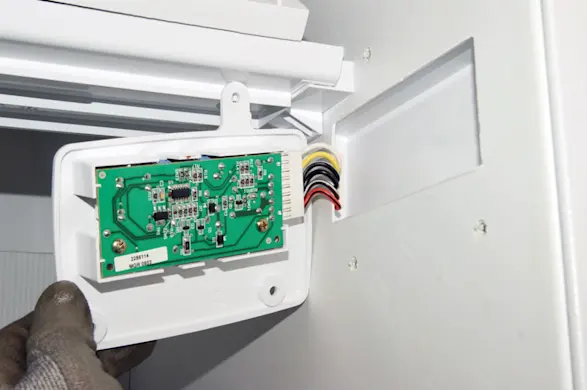 PHOTO: Pull the receiver board out slightly to access the wire harness connection.