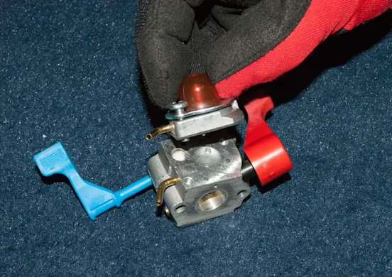 PHOTO: Remove the carburetor top cover.