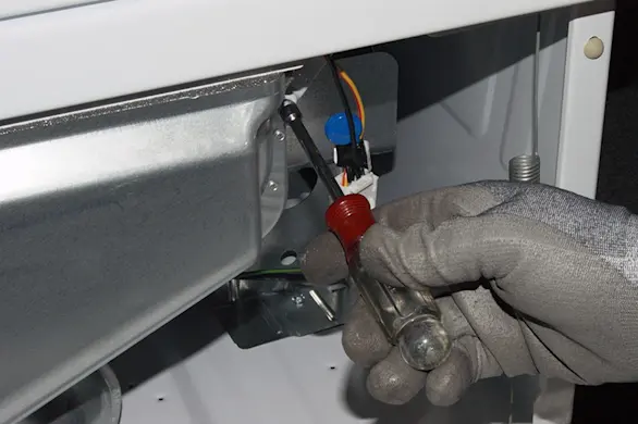 PHOTO: Remove the screws from the lint duct.