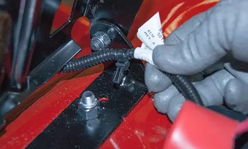 PHOTO: Reconnect the seat switch wire harness clip.