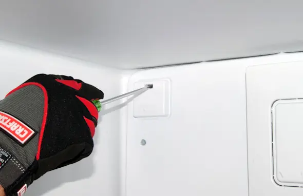 PHOTO: Release the harness cover locking tab.