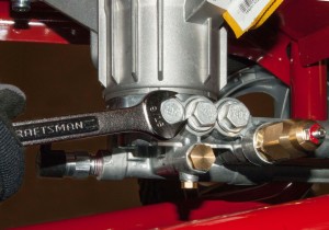 PHOTO: Loosen the manifold check valve caps.