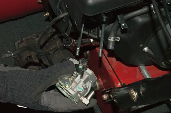 PHOTO: Remove the carburetor from the snowblower engine.