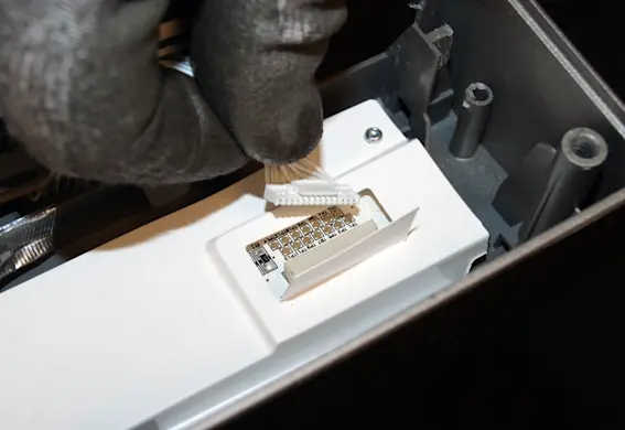PHOTO: Unplug the ribbon wire from the control panel.