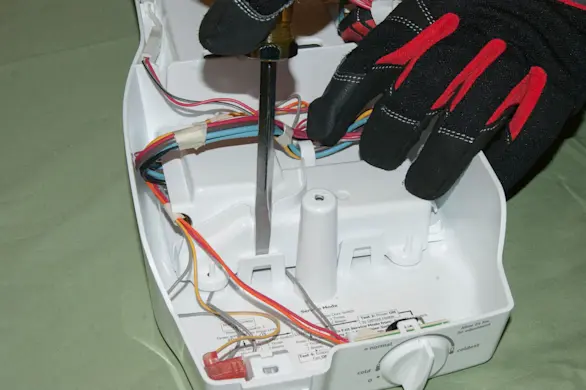 PHOTO: Release the control board housing locking tabs.