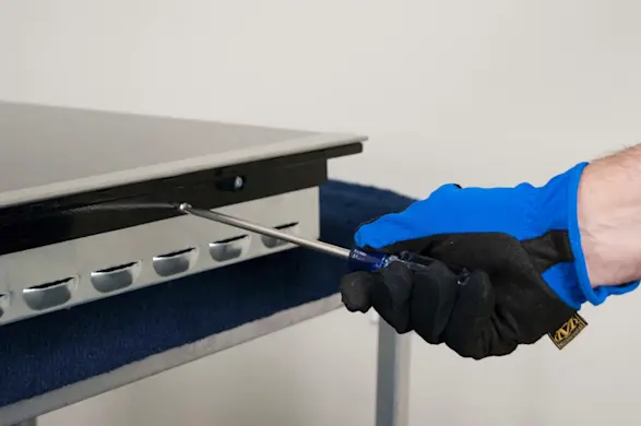 PHOTO: Remove the screws that attach the cooktop to the burner box.