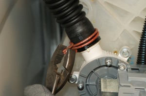PHOTO: Release the drain hose spring clamp.