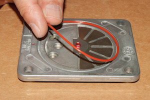 PHOTO: Install the new lower valve plate seal.