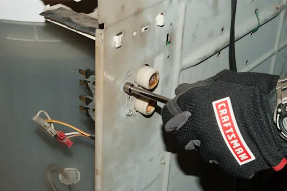 PHOTO: Remove the water inlet valve mounting screws.