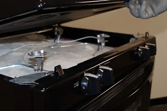 PHOTO: Lift up the front of the cooktop.