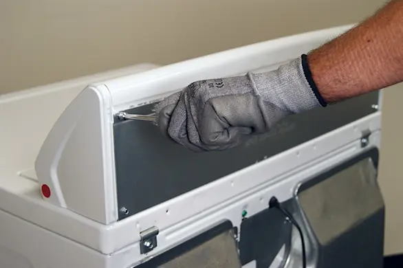PHOTO: Remove the screws from the panel at the back of the dryer console.