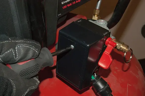 PHOTO: Remove the new pressure switch cover.