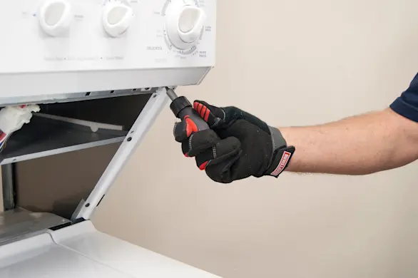 PHOTO: Remove the control panel mounting screws.