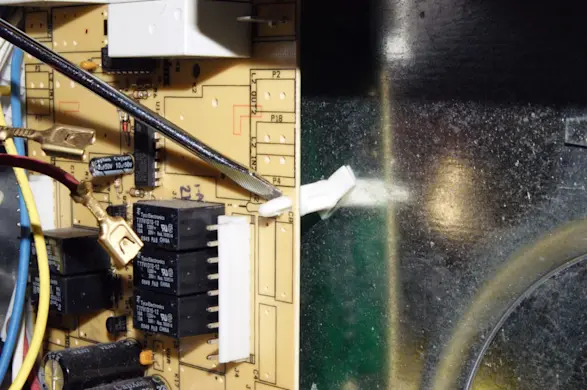 PHOTO: Release the relay control board mounting clips.
