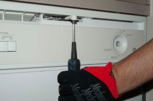 PHOTO: Remove the dishwasher door latch handle knob.