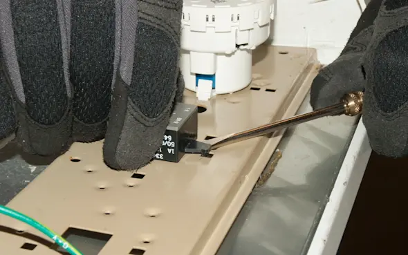 PHOTO: Release the water temperature switch locking tab.