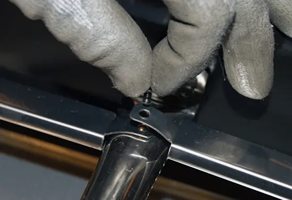 PHOTO: Remove the burner mounting screw.